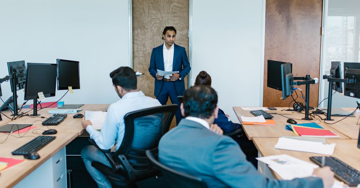 Business meeting with diverse team in modern office space, discussing projects.